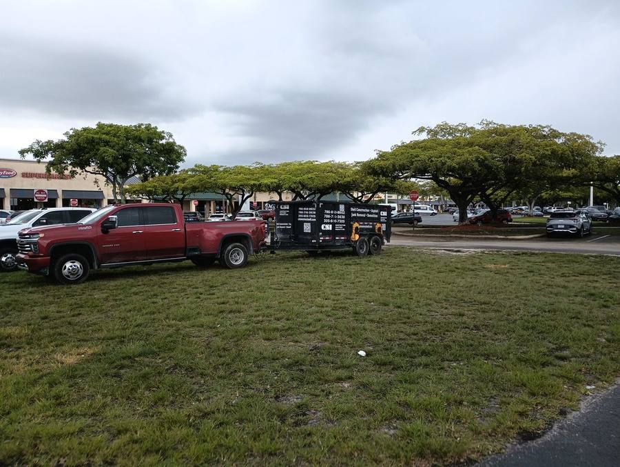CSI Construction lettered work trailer in shopping center parking lot