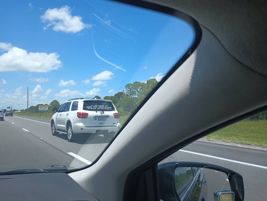 Creative Catering white SUV with window vinyl on I-95