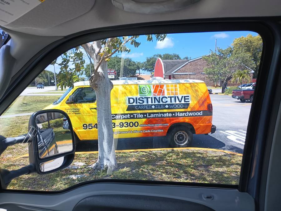 Distinctive Carpet full van wrap through window at intersection