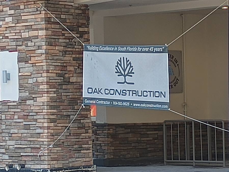 Oak Construction job site banner on building facade